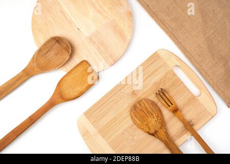 A set of wooden spatulas, cutting boards and a linen napkin on a light background. Top view with space to copy. Stock Photo