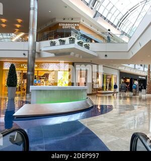 Orlando, FL USA - November 20, 2020:  Riding down an escalator at Millenia Mall in Orlando, Florida Stock Photo