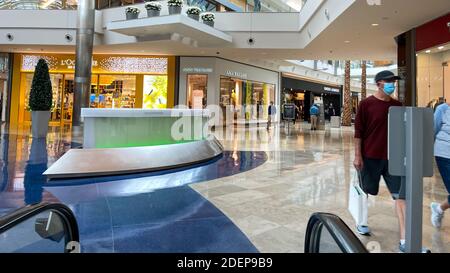 Orlando, FL USA - November 20, 2020:  Riding down an escalator at Millenia Mall in Orlando, Florida Stock Photo