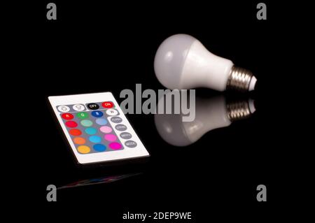 Remote control for light emitting diode LED theme light bulb isolated on the black background Stock Photo