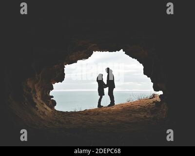 Romantic couple standing in front of the seascape. Picture of a proposal with text space Stock Photo