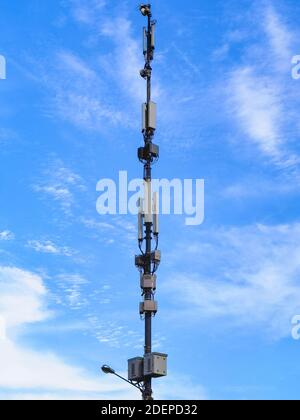 5G antenna pole for 5G telephone and internet communication, IOT Internet of things connections and millimeter wave transmission, isolated against a b Stock Photo