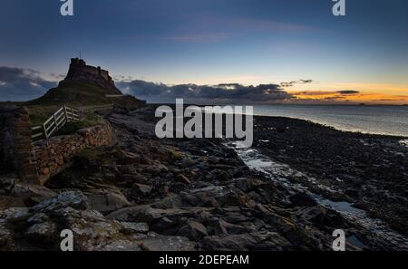 Lindisfarne Castle built by King Henry VIII to guard the Fleet anchorage in the Harbour of Holy Island. The Castle is built on a volcanic outcrop and Stock Photo