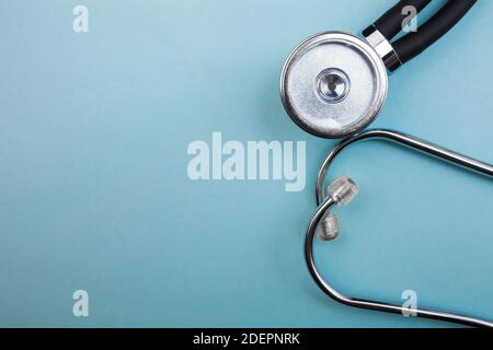 Medical pressure gauge and stethoscope on light blue background, for heart listening, isolated place Stock Photo