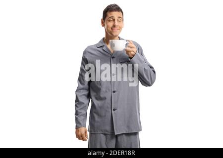 Young man in pajamas enjoying a cup of tea isolated on white background Stock Photo