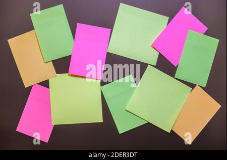 Many small sheets of colored paper to write on the notes on the wall. Stock Photo