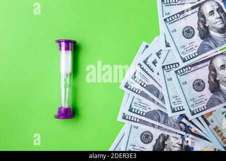 Many bills of 100 dollars, us banknote, green background with money cash currency close-up, concept time worth money Stock Photo