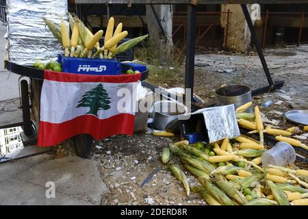 Clashes between demonstrators and counter-protesters by pro-Iranian Hezbollah supporters who attacked protestors in the centre of the capital Beirut during the 13th day of anti-government protests, Dozens of rioters descended on to Riad al-Solh Square near the government headquarters in Beirut, where they attacked protesters, torched tents, and tore down banners calling for 'revolution'. The unprecedented attack on the main site of the capital's largely peaceful protest movement forced the army and riot police to deploy en masse to contain the violence. Beirut, Lebanon, on October 29, 2019. Ph Stock Photo