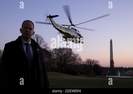 A US Secret Service agent stands by as Marine One departs carrying US President Donald J. Trump en route to a rally in Michigan; on the South Lawn of the White House, in Washington, DC, USA, 18 December 2019. The US House of Representatives is poised to vote on two articles of impeachment against US President Donald J. Trump, for abuse of power and obstruction of Congress. If passed, Trump would become the third US president in history to be impeached. An impeachment would lead to a trial in the US Senate, where a two-thirds vote of approval would be necessary in order to remove Trump as presi Stock Photo
