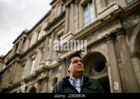 Low View of Man Standing outside the Louvre in Paris Stock Photo