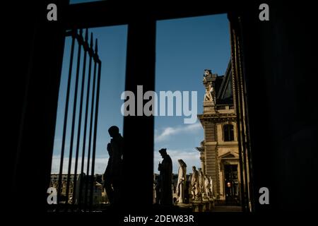 Indoor Window View of Statues on Top of the Louvre in Paris Stock Photo