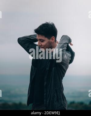 young man sheltering in mountains Stock Photo