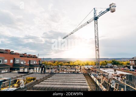 Construction worker working on a reinforced concrete slab at dawn Stock Photo