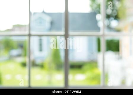 Blurred image of green garden and a house, view from window -abstract background Stock Photo