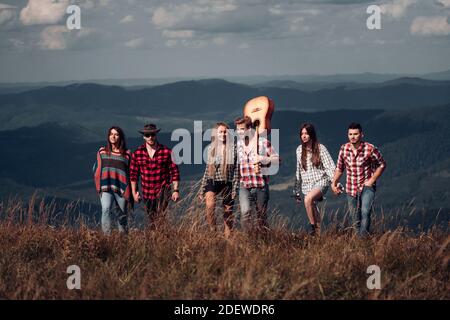 Group students on summer camp. Young Friends Relaxing on Camping. Stock Photo