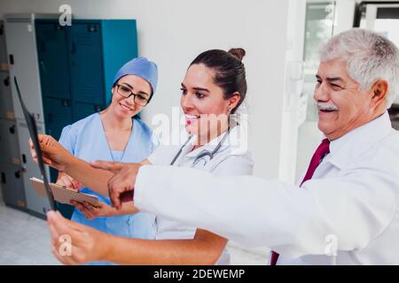 Group of latin doctors looking a radiography in a hospital Stock Photo