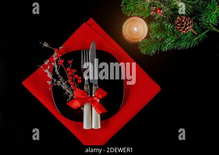 Christmas table setting with decorations and candle. Holiday New Year. Stock Photo
