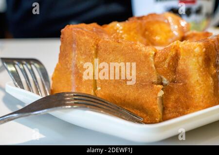 Classic dessert in Hong Kong tea restaurant, deep-fried western toast with condensed milk and peanut sauce Stock Photo