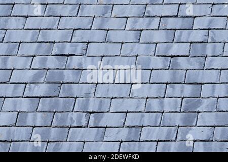 Gray background of roof with slate tiles. close-up and full screen. Stock Photo