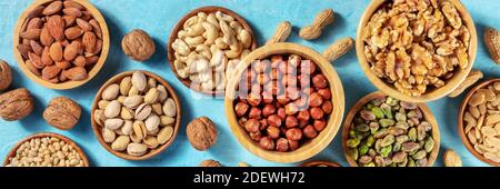 Nuts assortment panorama with many different nuts in wooden bowls Stock Photo