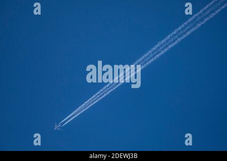 Contrails / Jet vapour trail of an airplane on the sky. Stock Photo