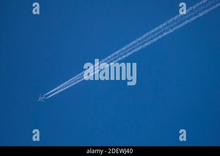 Contrails / Jet vapour trail of an airplane on the sky. Stock Photo