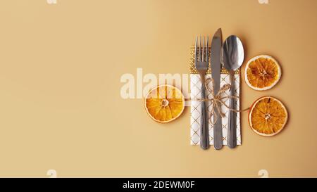 Setting of table with dry orange on gold background Stock Photo