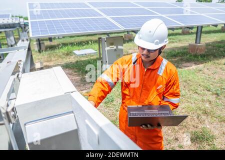 Engineers used a laptop for checking the performance of the controller box to confirming systems working normally. Concepts professional engineer for Stock Photo