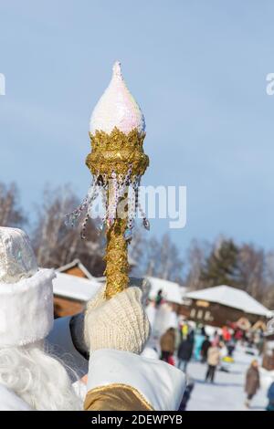 Irkutsk, Russia- 8 January 2019: Father Frost looking at the walking people and holding his golden magic wand in his right hand at the park of Ethnogr Stock Photo