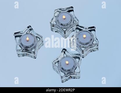 Four star formed glass led lights burning on a mirror Stock Photo