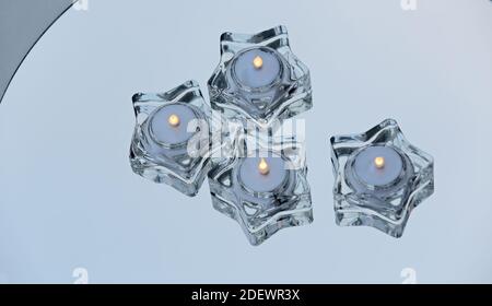 Four star formed glass led lights burning on a mirror Stock Photo
