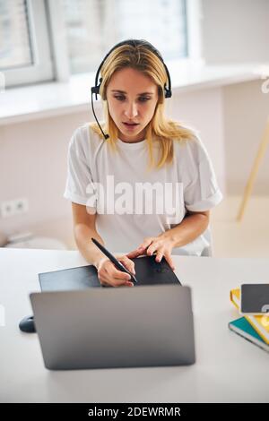 Digital artist hand-drawing images with a stylus Stock Photo
