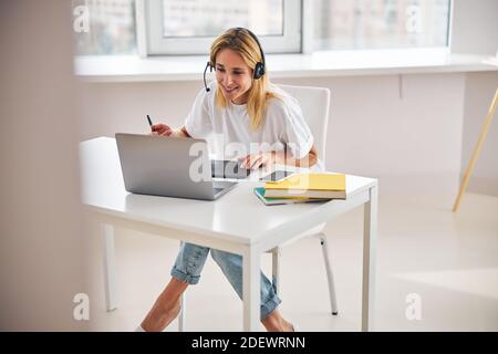 Joyous woman concentrated on creating digital art Stock Photo