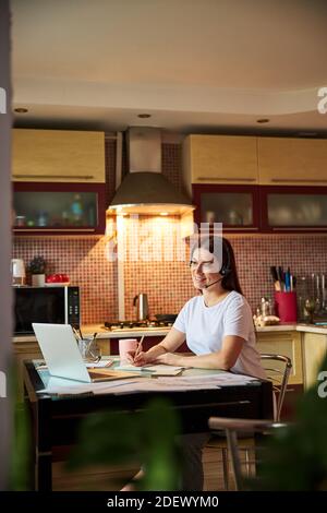 Female is participating at a video conference Stock Photo