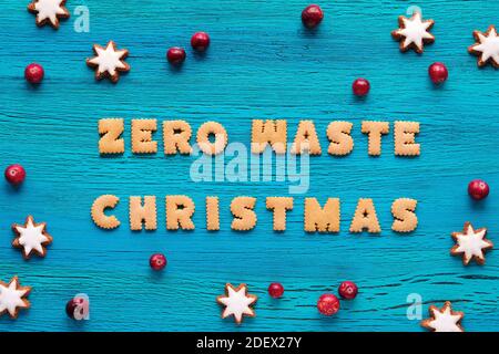Text Zero Waste Christmas made from cookies. Xmas top view with star cookies and fresh cranberry, Stock Photo