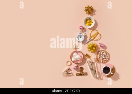 Creative Christmas tree shape made of office stationery, alarm clock, Christmas decoration elements Stock Photo
