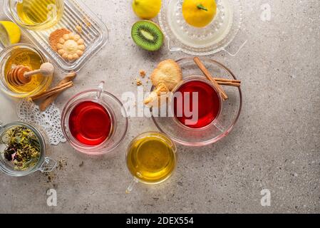 Herbal tea, green tea, fruit tea cups on grey background Stock Photo
