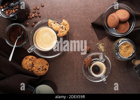 Cups of espresso coffee and cappuccino with coffee beans and coffee grinder on dark table Stock Photo