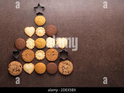 Christmas tree made from cookies and biscuits on dark background with copy space for text. holiday, celebration and cooking concept. new year and chri Stock Photo
