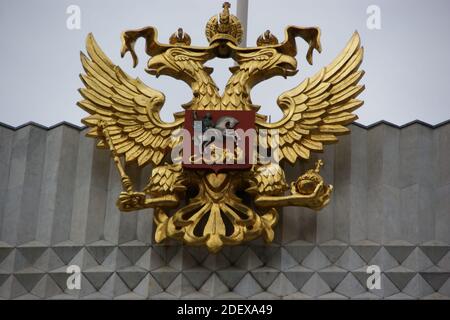 Two headed Russian Imperial Eagle holing the symbols of power, orb and sceptre with a red crest of a blue caped silver horseman slaying a gold dragon. Stock Photo
