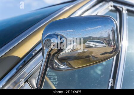 Close up detail of chrome door mirror on a gold Alfa Romeo Montreal classic sports coupe Stock Photo