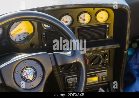 Steering wheel and dashboard console of a yellow Alfa Romeo RZ convertible sports car Stock Photo