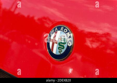 Close up of the brand logo emblem badge on the front of a red Alfa Romeo SZ sports coupe Stock Photo