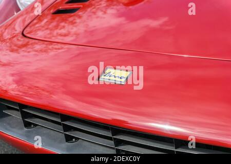 Close up of the logo emblem badge and bonnet of a red 1970s Ferrari Dino 246 GT small sports car Stock Photo