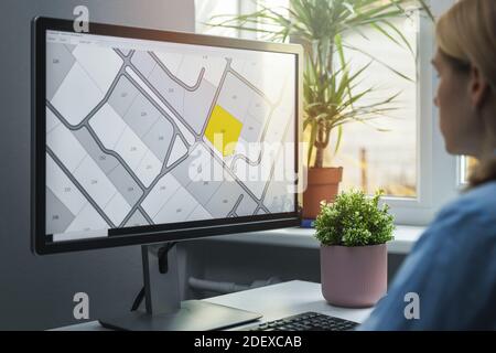 woman working with digital land registry database on computer in office Stock Photo