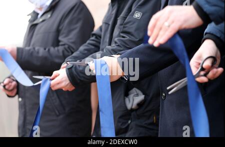 Barth, Germany. 02nd Dec, 2020. During the ceremonial opening of the planning office for the reconstruction of the Darßbahn and a travel agency, a ribbon is cut in front of the station building. Credit: Bernd Wüstneck/dpa-Zentralbild/dpa/Alamy Live News Stock Photo