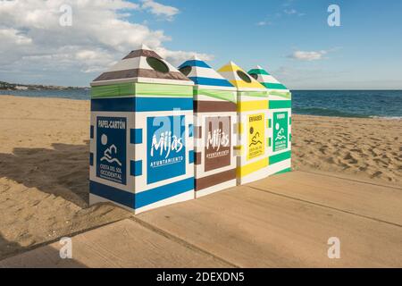 Four public waste disposal containers on the beach at La Cala de Mijas, Spain. Stock Photo