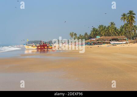 India, Goa, Colva beach, Fishermen  on boat sorting fishing nets Stock Photo