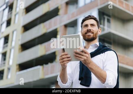 Architect working with tablet on construction project Stock Photo