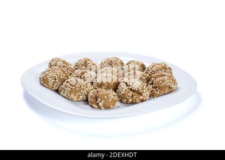 Vegan gingerbread with sesame on a white plate, isolated on a white. Stock Photo
